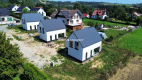 Nowe domy w sąsiedztwie terenów zielonych / Ujazd